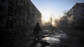 A Ukrainian soldier walks through ruins in Zaporizhzhia.