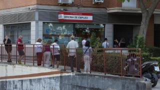 Desempleados delante de una oficina de empleo.