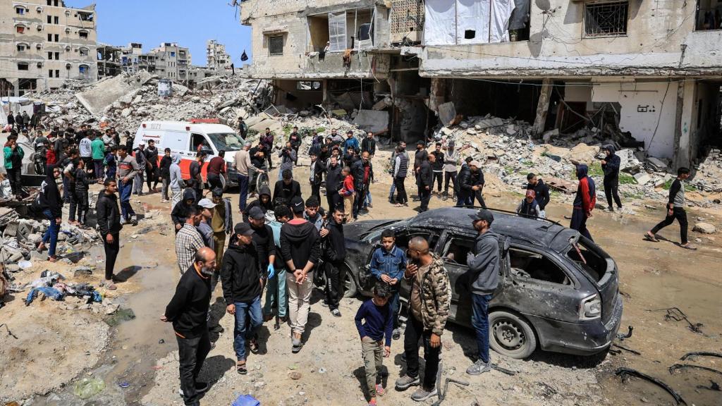 Palestinians inspect the damage after an Israeli projectile hit a cyclist, according to medical services, in Gaza City, April 6, 2026.