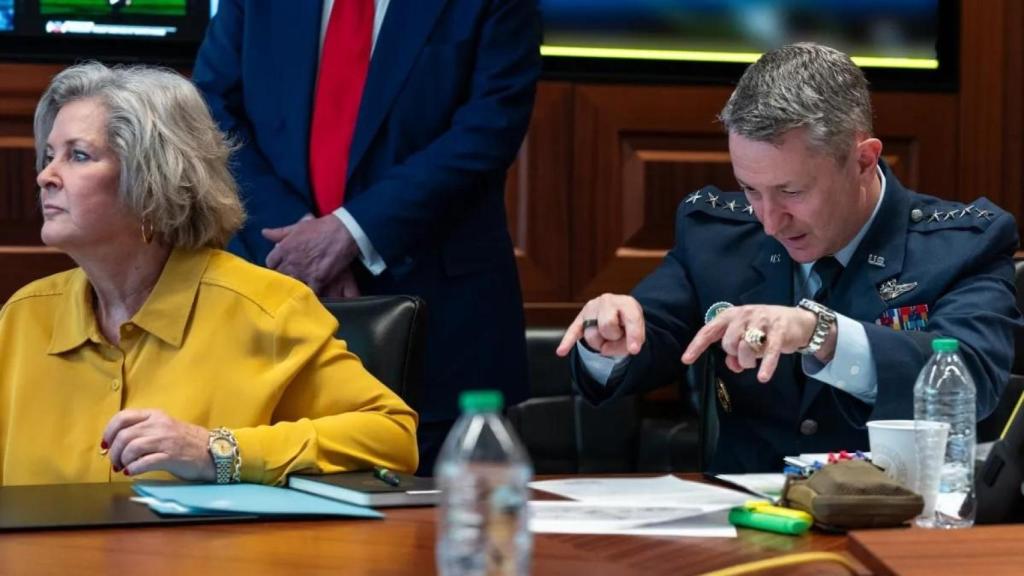 General Dan Caine appears to invoke a spell in a meeting in the Crisis Room with Susie Wiles, White House Chief of Staff.