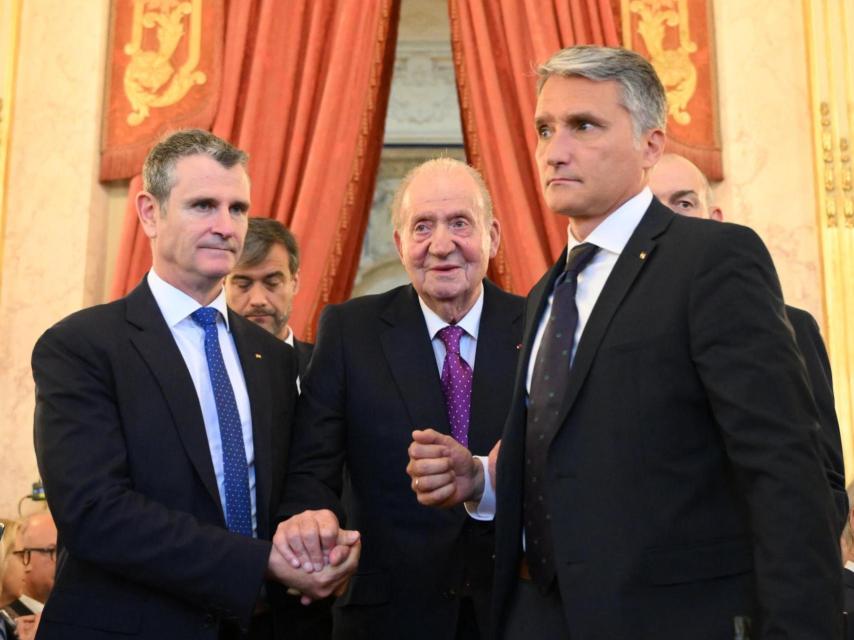 El rey Juan Carlos I, acompañado por dos de sus escoltas, en la 35ª edición del Libro Político, en París.