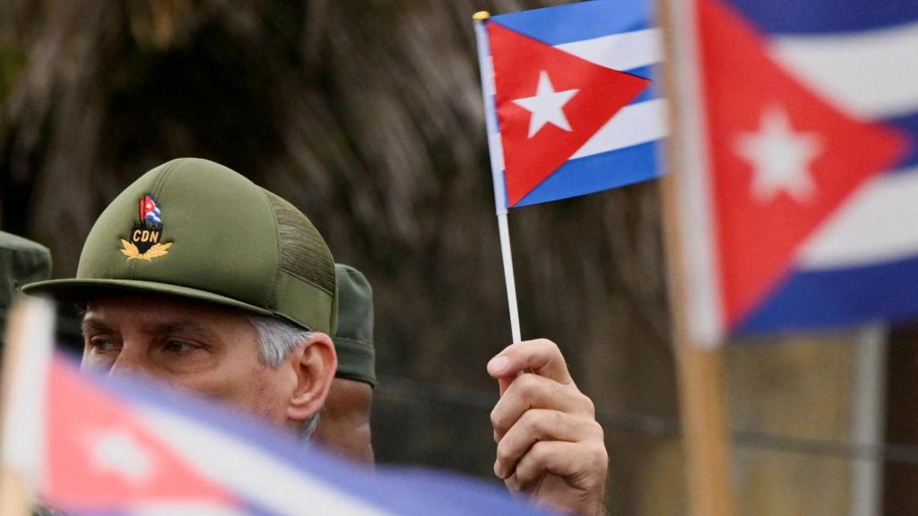 The President of Cuba, Miguel Díaz-Canel, waves a Cuban flag during a march in front of the United States Embassy to protest against what they denounce as US aggression in the region, in Havana, Cuba, January 16, 2026.