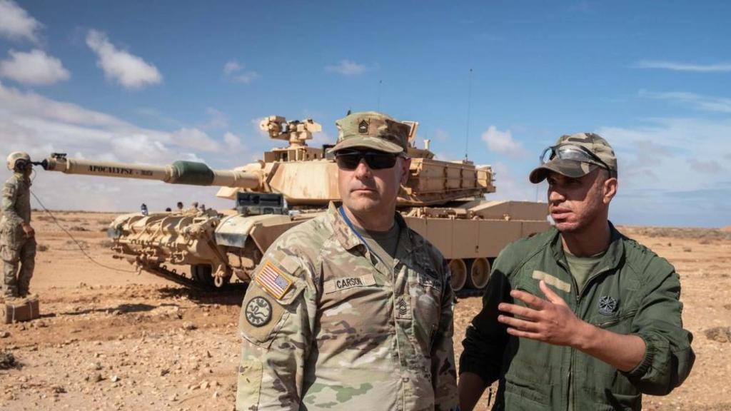 An American armor sergeant with a Moroccan officer during the 'African Lion' maneuvers