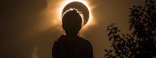 Una niña observa un eclipse solar