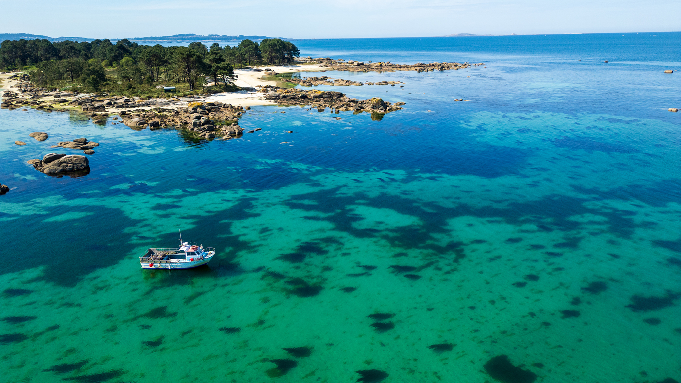 Barco pesquero en aguas turquesas de Illa de Arousa.