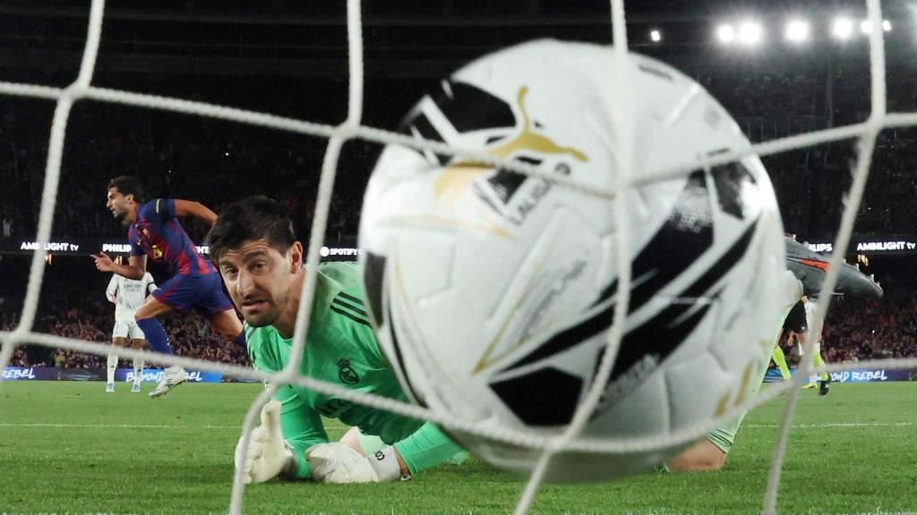 Thibaut Courtois looks at the ball into his goal during Ferran Torres' goal in El Clásico