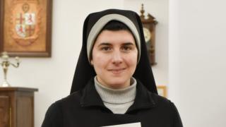 Sor Marta mostrando su placa de 100.000 suscriptores en YouTube.