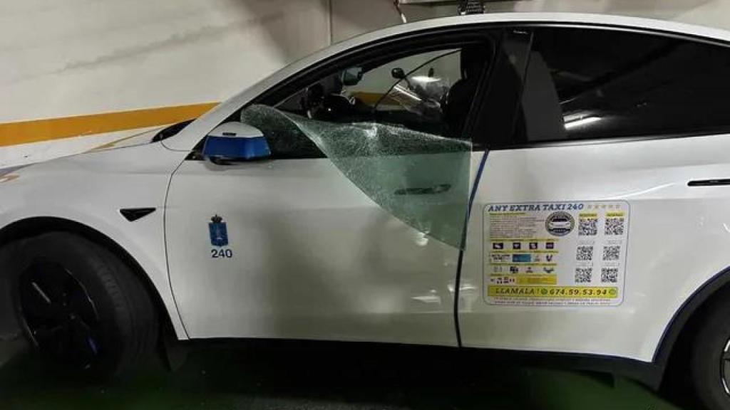 Imagen del taxi con la ventanilla rota tras el robo.