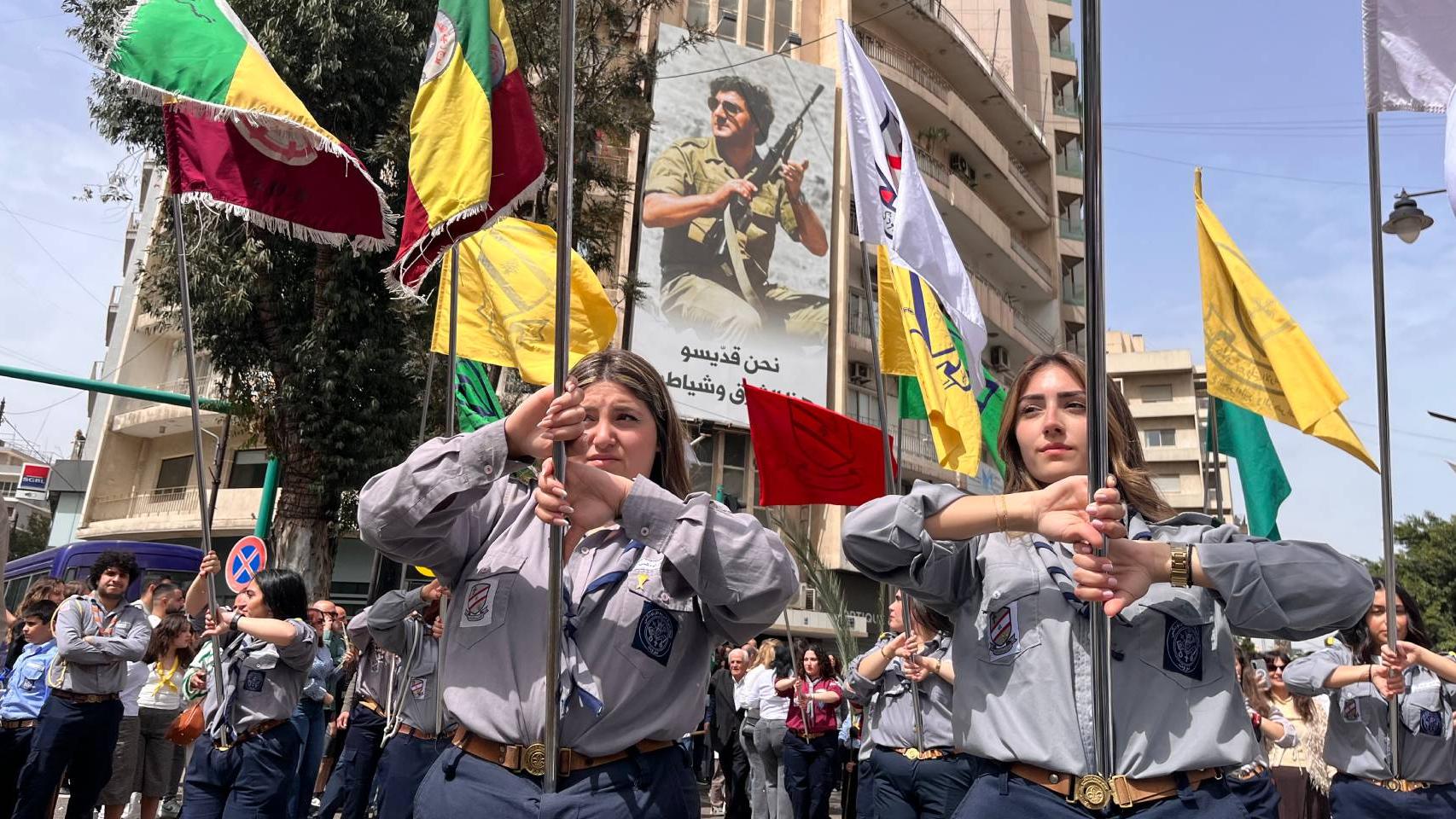 Scouts católicas en Líbano pasando bajo propaganda militar