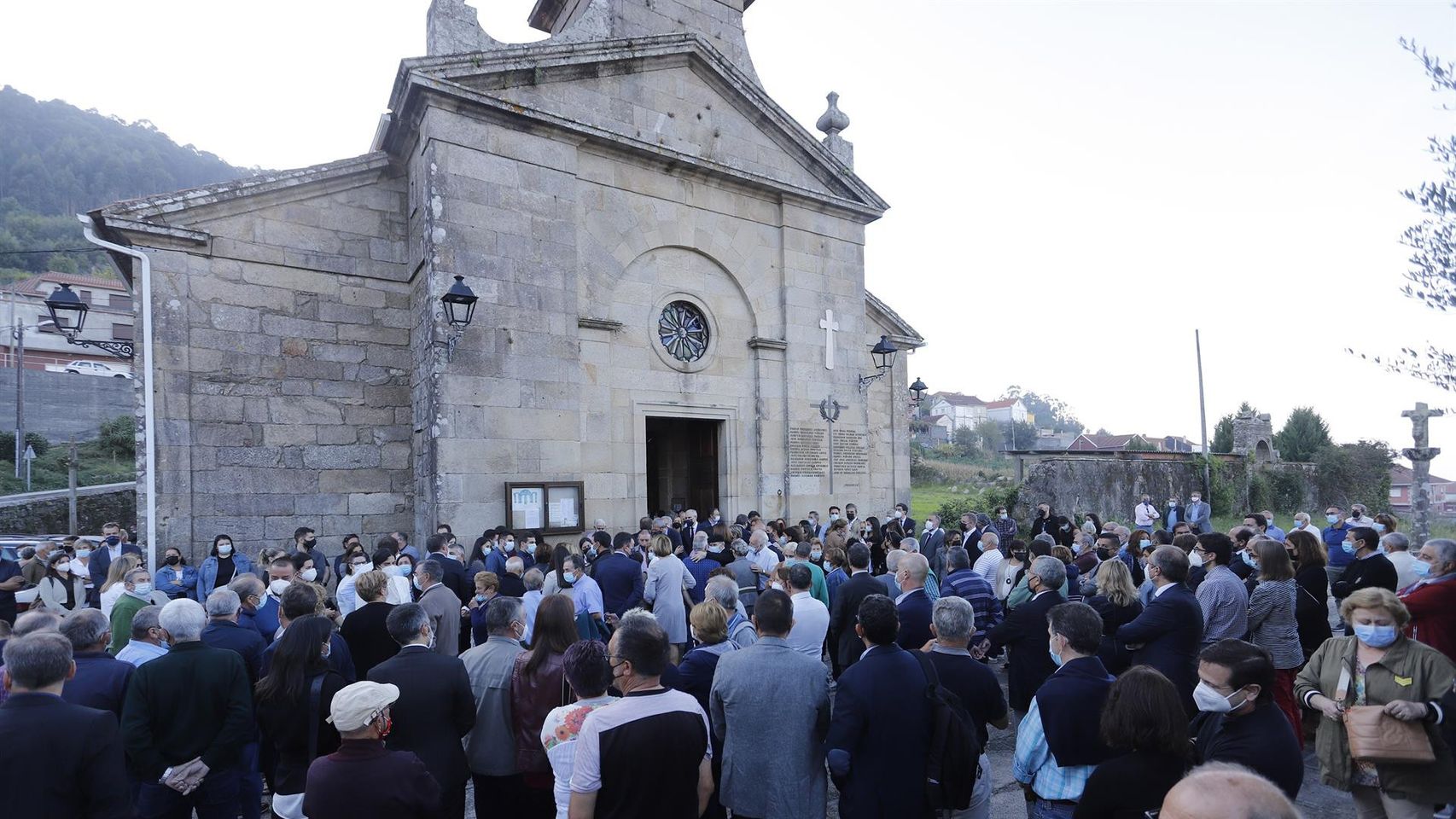 Numerosas personas, entre ellas los miembros del Gobierno gallego encabezados por el presidente Alberto Núñez Feijóo, asisten en Bueu (Pontevedra) al funeral del conselleiro de Facenda, Valeriano Martínez.