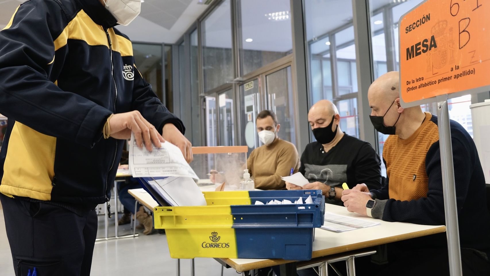 Un empleado entrega el voto por correo en una mesa electoral en las elecciones de Castilla y León